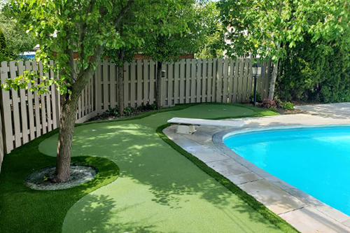 Putting green next to swimming pool