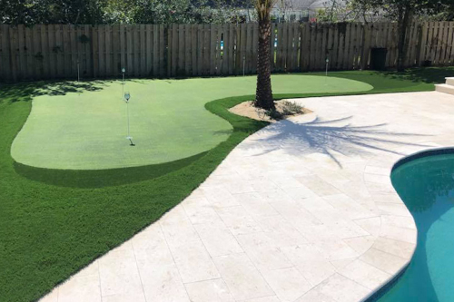 Mid-sized putting green near residential pool